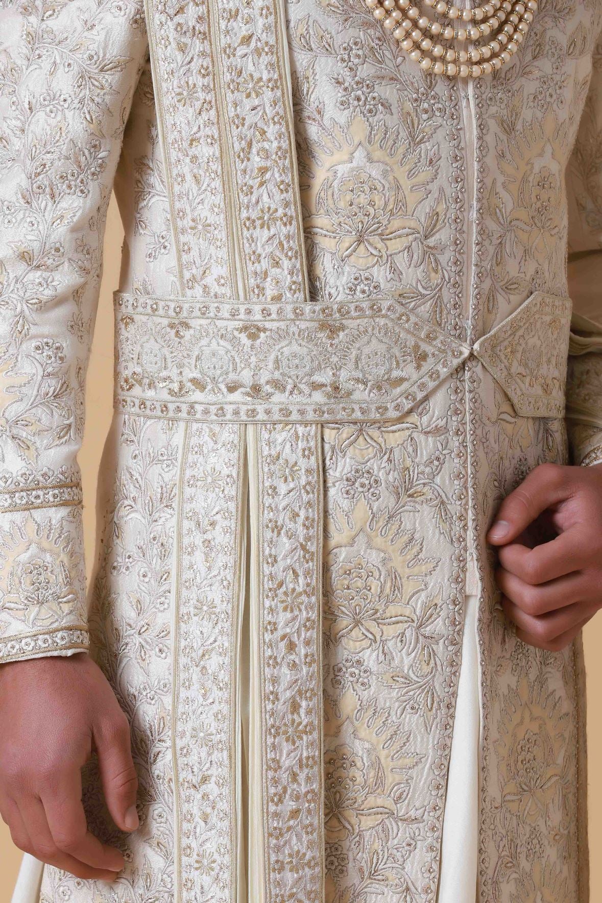 Exude regal elegance in this off-white Sherwani crafted from raw silk. Shop Now!