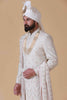 Elevate your style with this off-white sherwani, featuring a blend of geometric and floral embroidery. Complete with pleated kurta, pajama, and Kamarband for a refined ensemble.