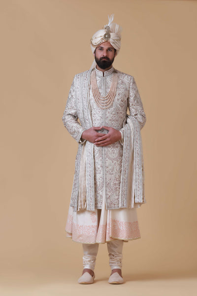 Charm in beige and pink hues with this elegant Sherwani, adorned with intricate embroidery for a touch of sophistication.