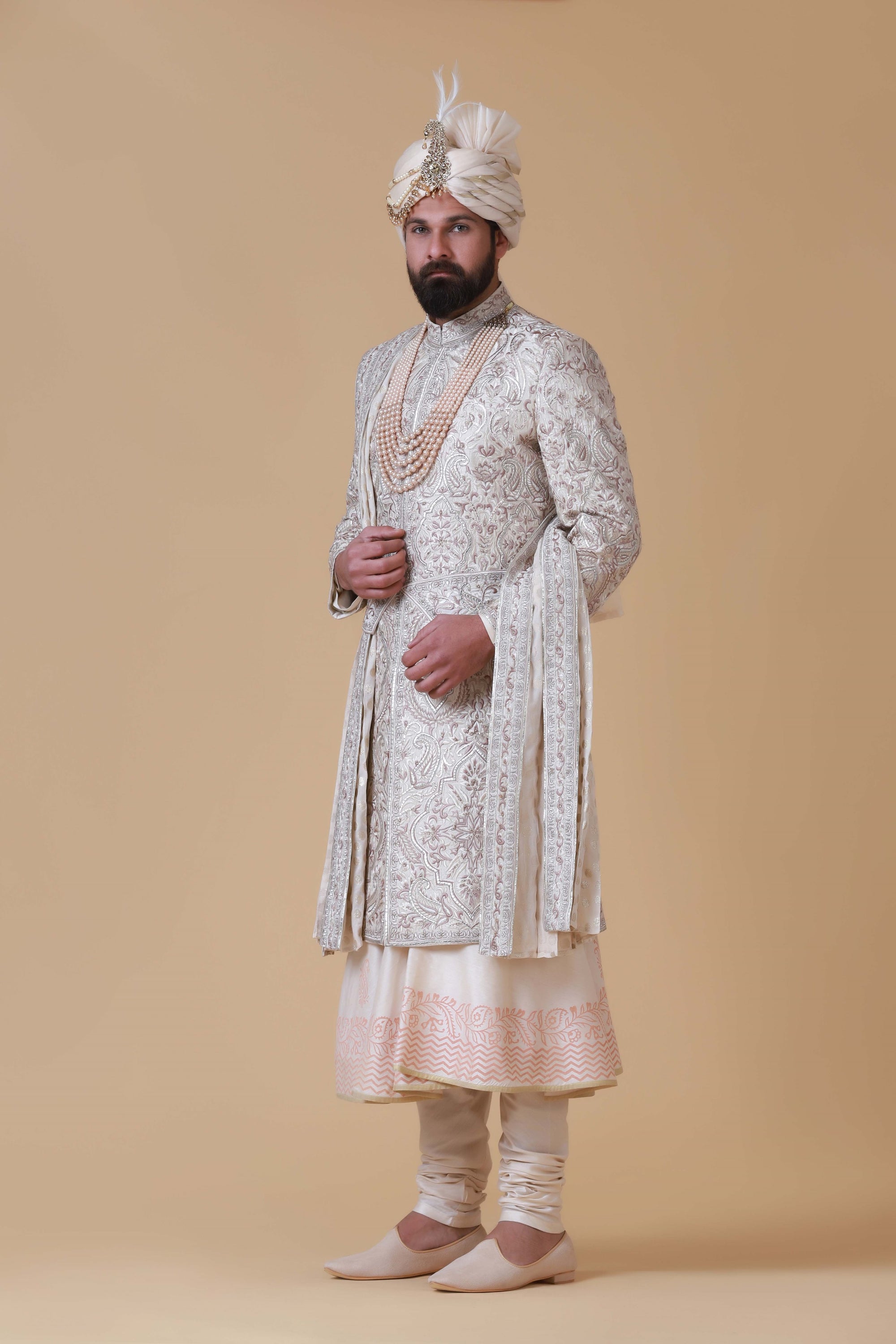 Charm in beige and pink hues with this elegant Sherwani, adorned with intricate embroidery for a touch of sophistication.