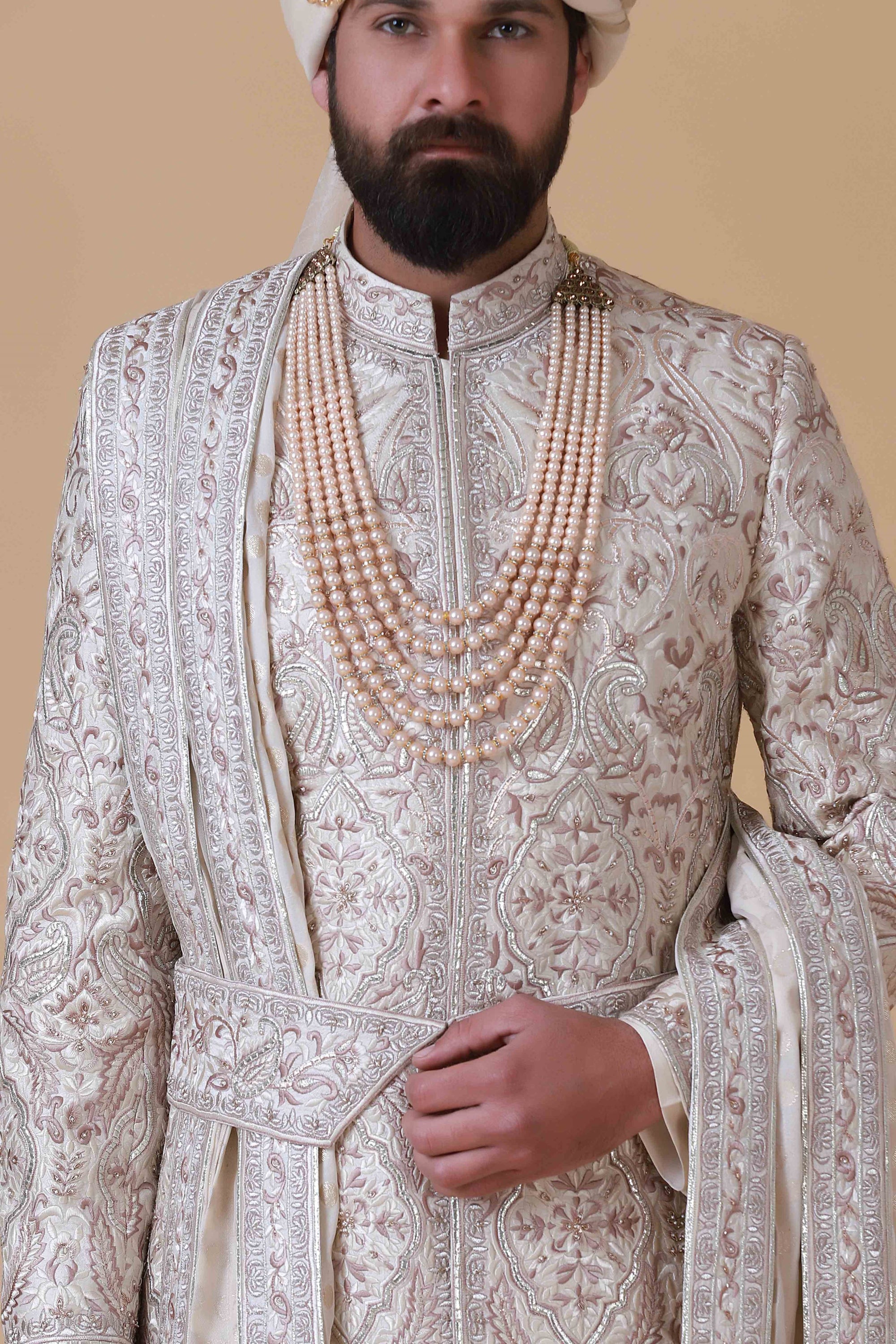 Charm in beige and pink hues with this elegant Sherwani, adorned with intricate embroidery for a touch of sophistication.