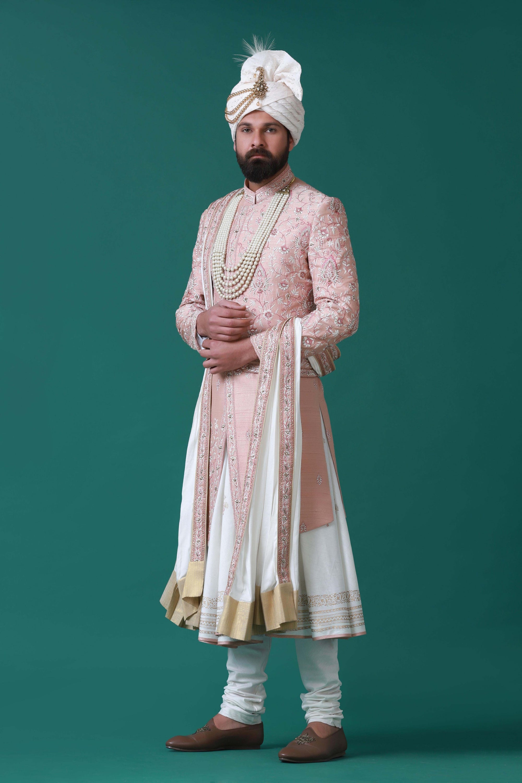 Elegant peach sherwani with tonal floral embroidery, paired with a pleated kurta and pajama set for a timeless ensemble.
