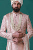 Elegant peach sherwani with tonal floral embroidery, paired with a pleated kurta and pajama set for a timeless ensemble.