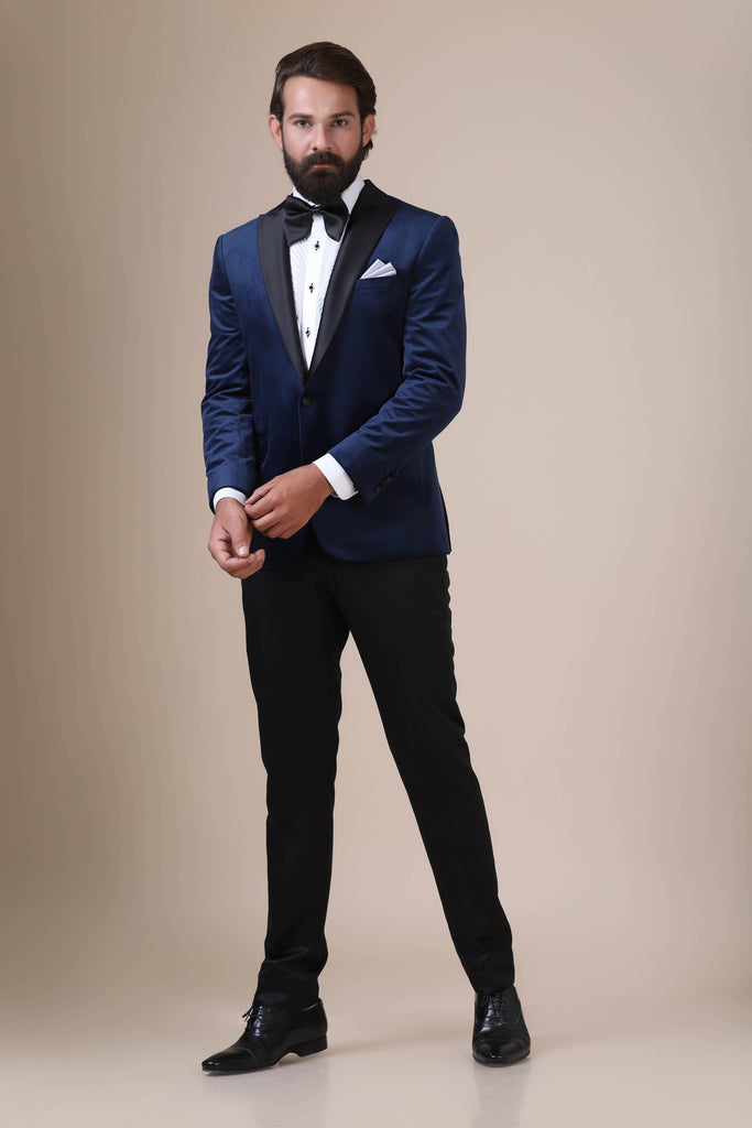 Step into sophistication with our navy velvet Tuxedo. Notched lapel, single button closure. Paired with Jet-Black trousers for timeless elegance.