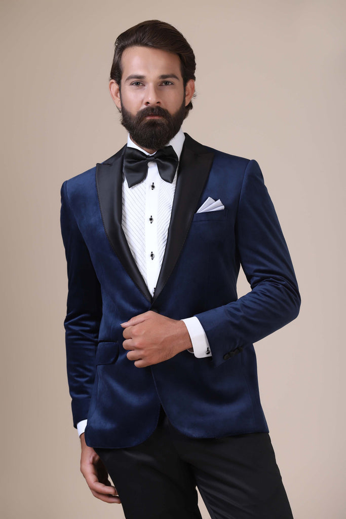 Step into sophistication with our navy velvet Tuxedo. Notched lapel, single button closure. Paired with Jet-Black trousers for timeless elegance.