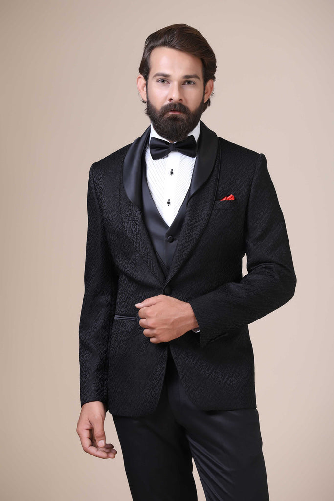 Experience sophistication in our designer 3-Piece Tuxedo. Contemporary shawl collar design with jacquard fabric and satin. Jet-black tapered trousers complete the ensemble.
