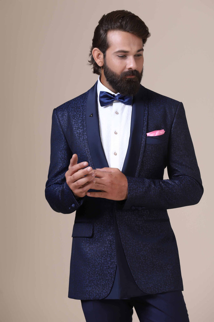 Exude sophistication in our classic Tuxedo. Italian-cut shawl collar, single button closure. Crafted from 100% Italian wool jacquard with a hint of Lurex, paired with Navy tapered trousers.