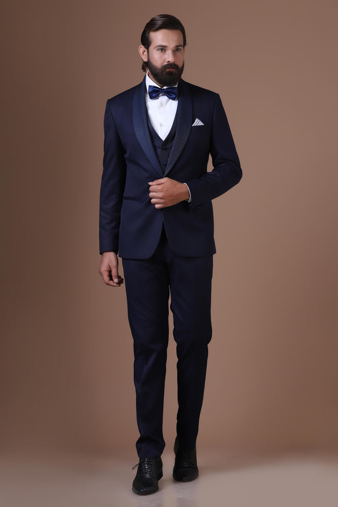Elevate your style with our 3-Piece Tuxedo featuring contrast lurex fabric on the shawl collar and waistcoat. Jet-Blue fabric completes the ensemble.