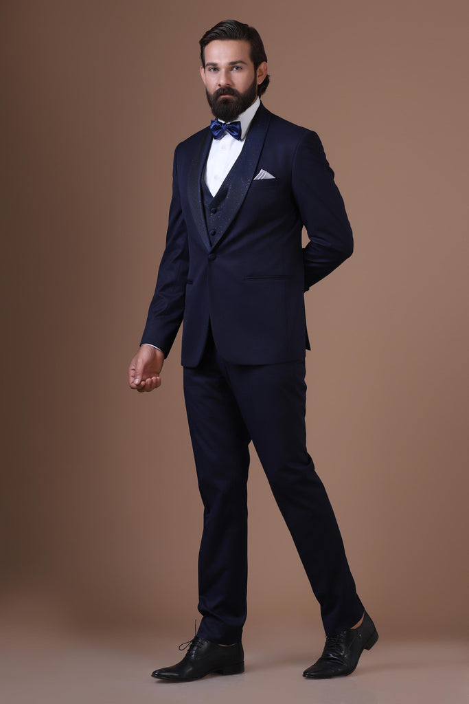 Elevate your style with our 3-Piece Tuxedo featuring contrast lurex fabric on the shawl collar and waistcoat. Jet-Blue fabric completes the ensemble.