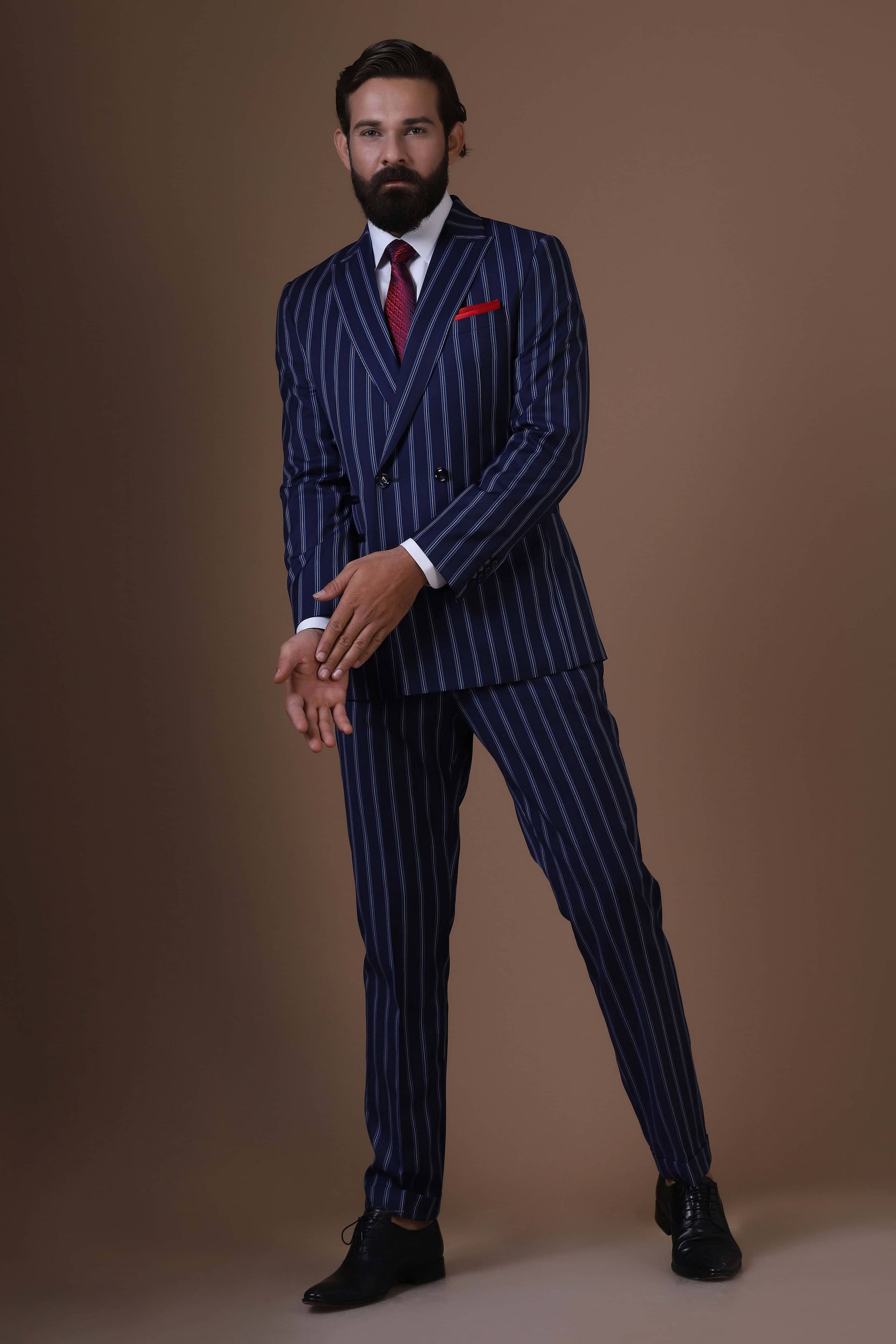 Make statement with our bold double-breasted suit in striking navy blue pin-stripe fabric. Shop Now!