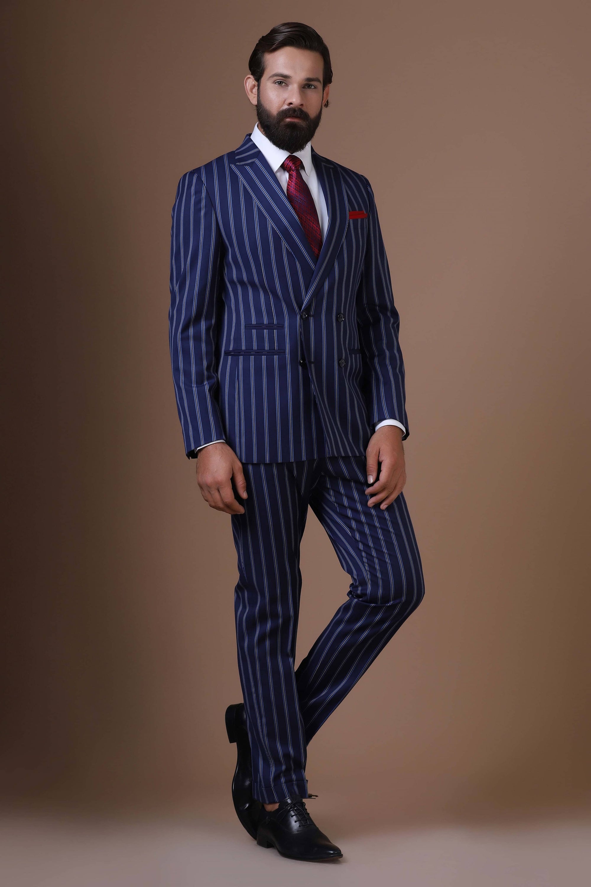 Make statement with our bold double-breasted suit in striking navy blue pin-stripe fabric. Shop Now!