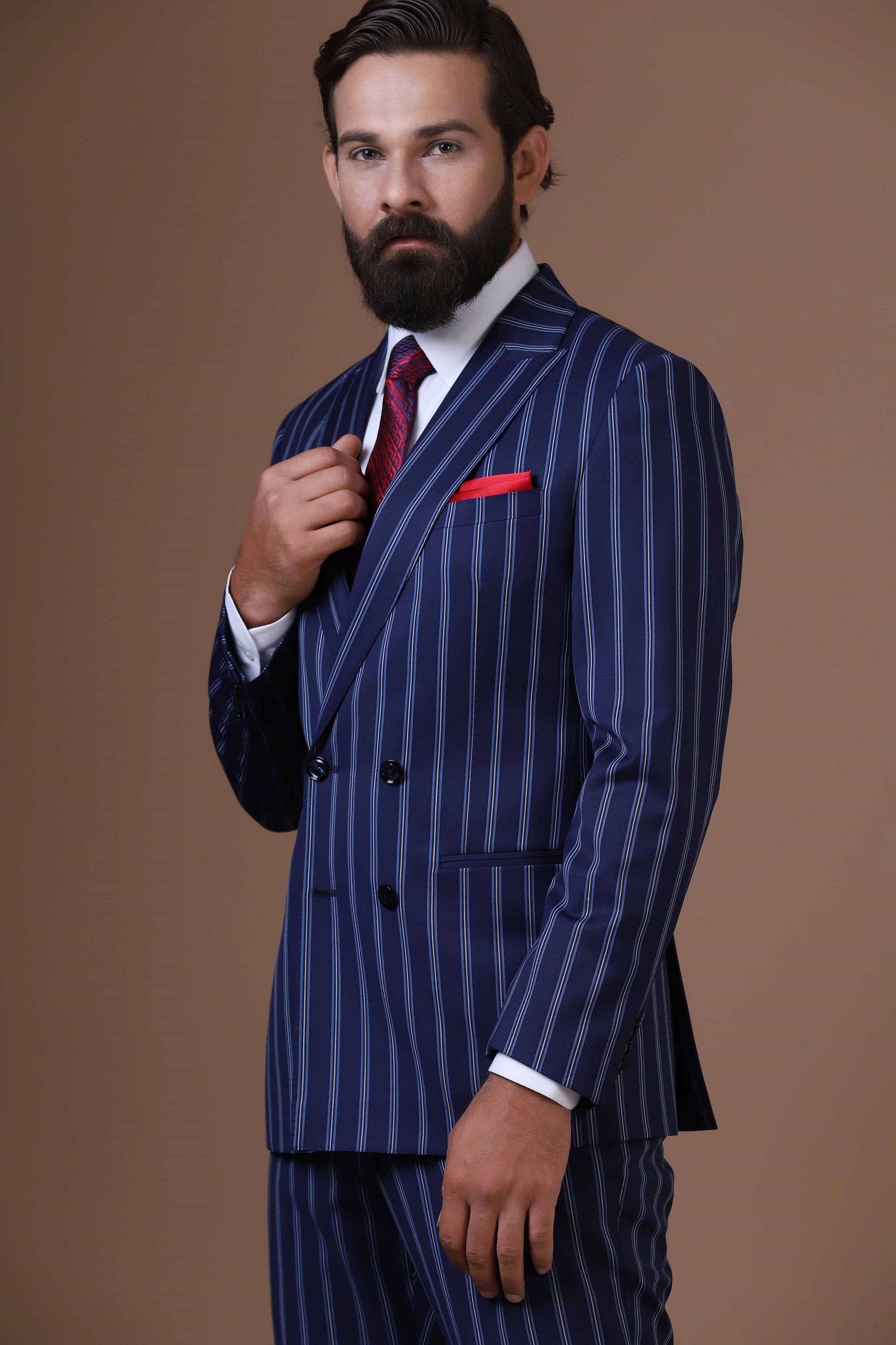 Make statement with our bold double-breasted suit in striking navy blue pin-stripe fabric. Shop Now!