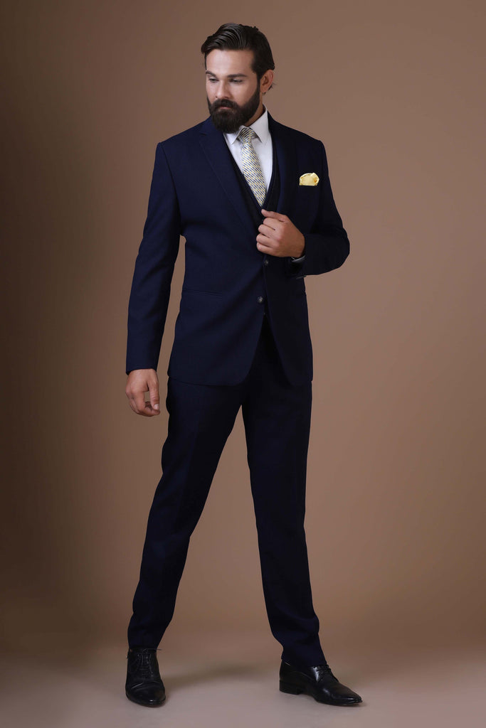 Elevate your style with our 3 Piece suit featuring a contrast jacquard waistcoat. Notched lapel, 2-button closure, crafted from textured Navy Blue fabric.