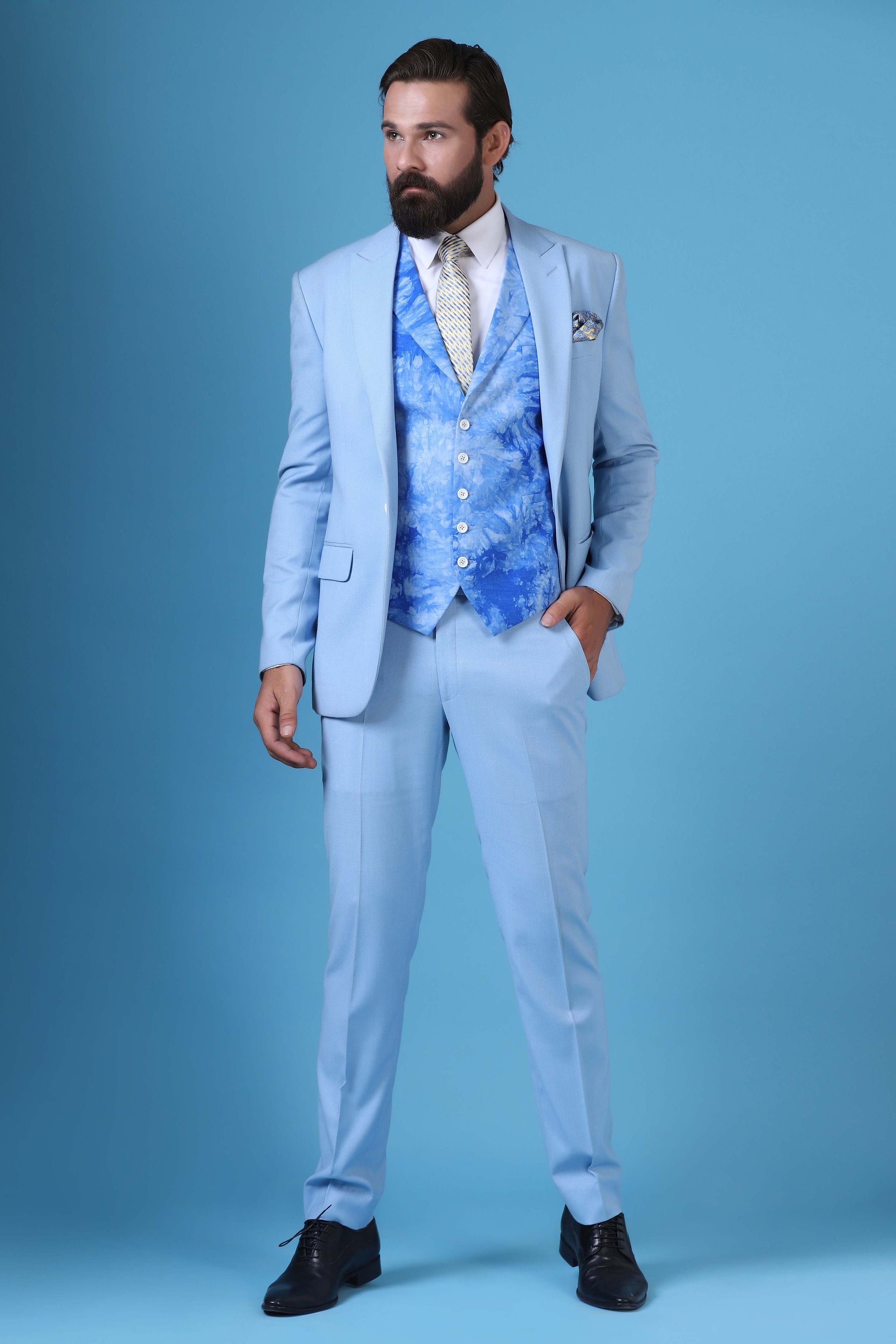 Elevate your style with this 3-piece suit featuring a printed waistcoat with a peak lapel. Shop Now!