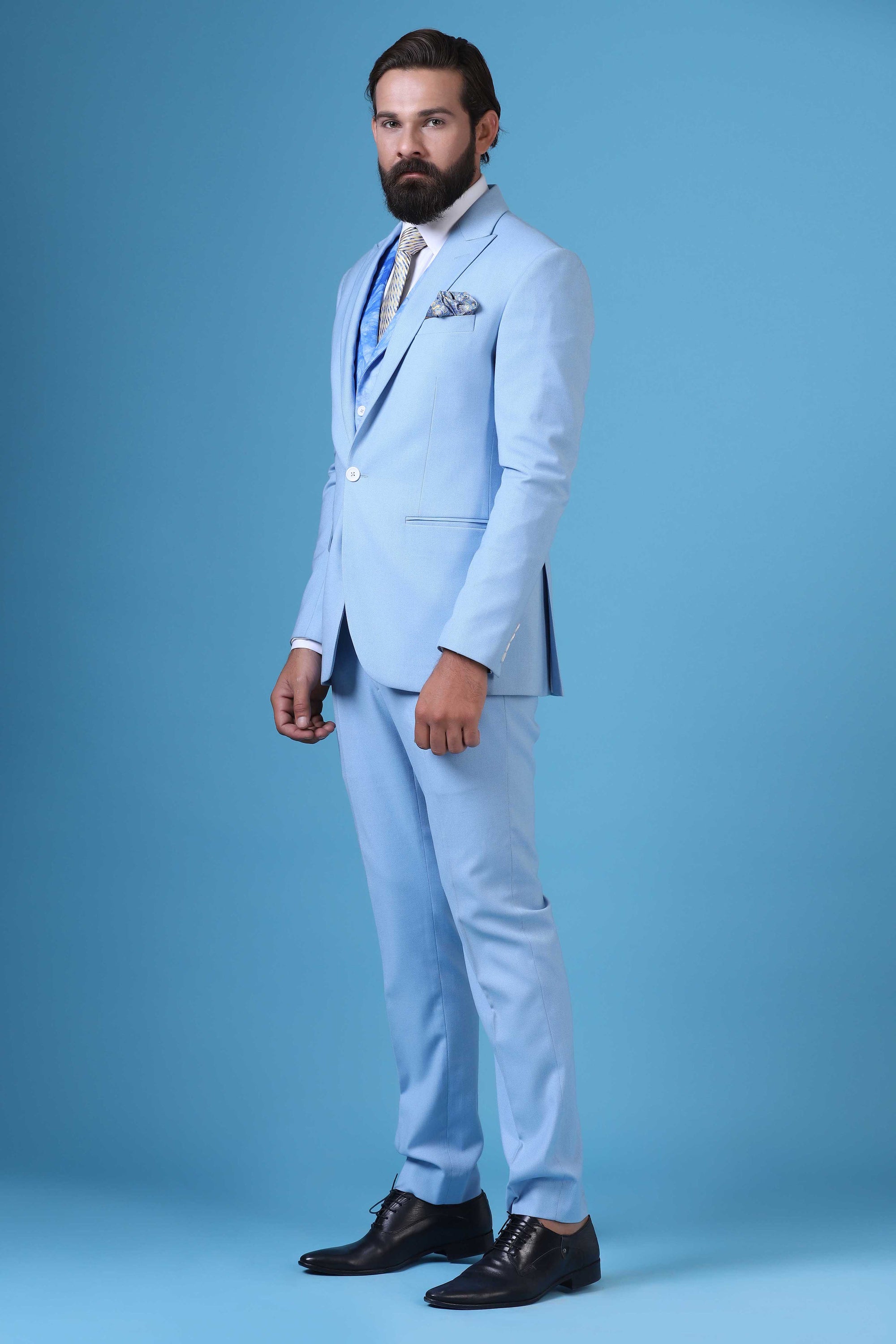 Elevate your style with this 3-piece suit featuring a printed waistcoat with a peak lapel. Shop Now!