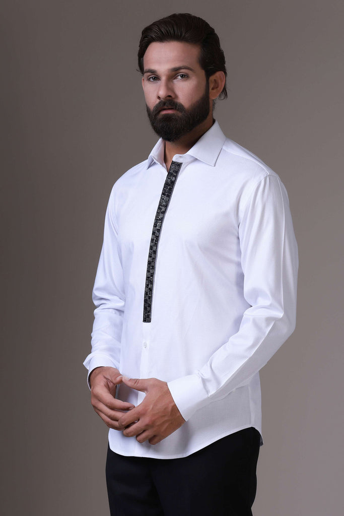 Enhance your evening attire with this white textured cotton shirt, adorned with intricate black embellished embroidery along the placket for a touch of elegance.