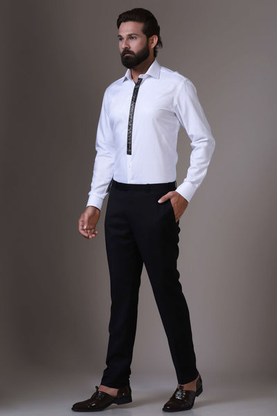 Enhance your evening attire with this white textured cotton shirt, adorned with intricate black embellished embroidery along the placket for a touch of elegance.