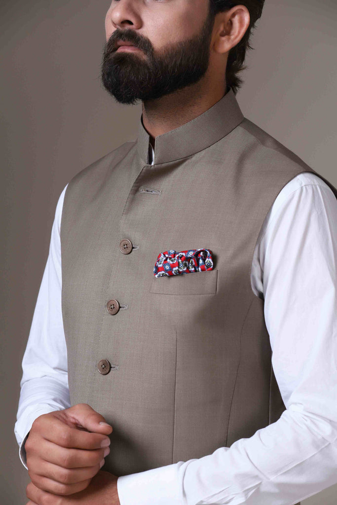 Elevate your style with our beige Nehru Jacket crafted from wool-rich fabric. Its lightweight construction and minimalist design transition seamlessly from business meetings to wedding events.