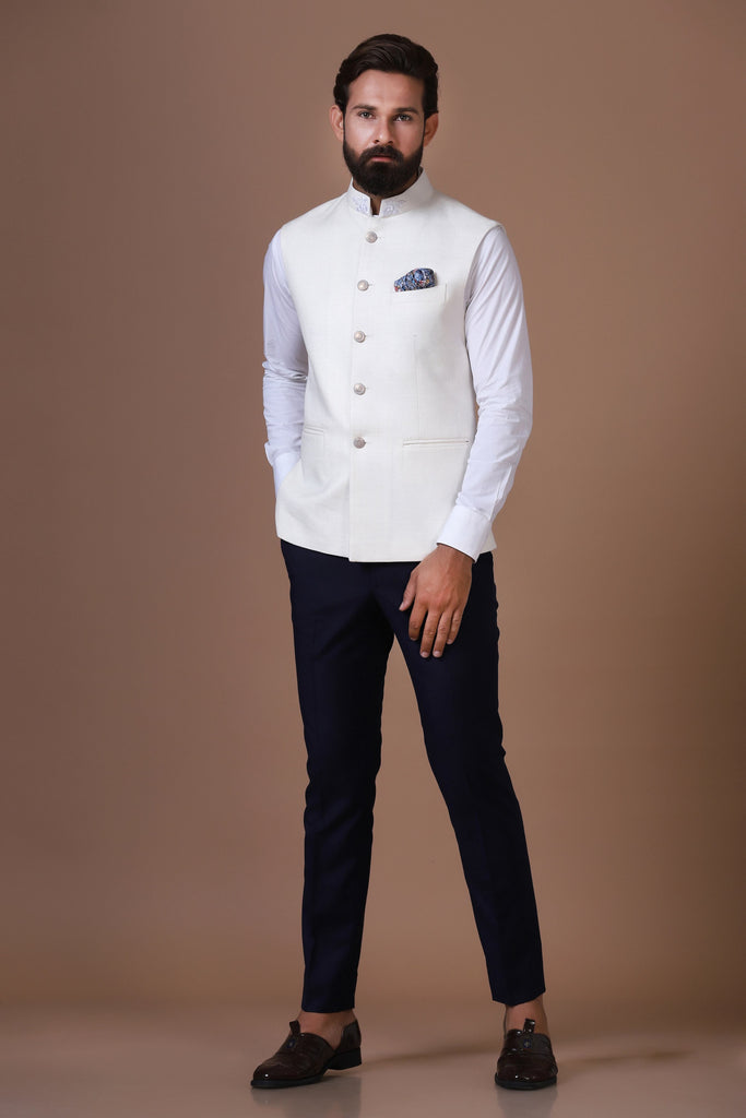 Exude elegance with our classic white Nehru Jacket, crafted from handloom silk fabric. Subtle embroidery on the collar adds a touch of sophistication to this timeless design.