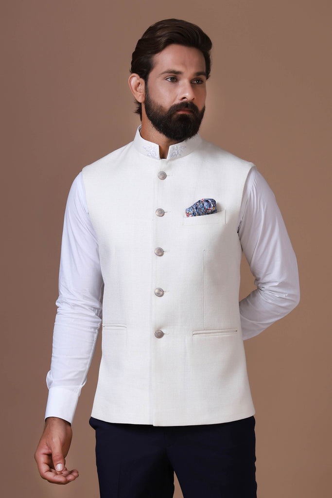 Exude elegance with our classic white Nehru Jacket, crafted from handloom silk fabric. Subtle embroidery on the collar adds a touch of sophistication to this timeless design.