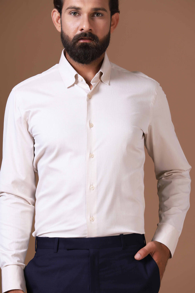Timeless elegance meets comfort in our 100% cotton beige shirt. Concealed button-down collar and French placket for refined sophistication.