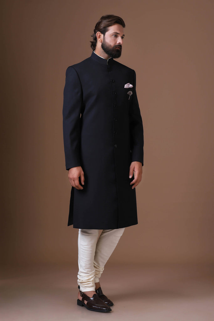 Refined simplicity meets traditional charm. Our black Achkan, crafted from premium wool-rich fabric, features a classic straight cut, 7 buttons, and a single breast pocket. Complete with a kurta pajama ensemble for effortless elegance.