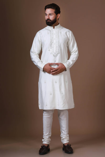 Enhance your style with our white embroidered Kurta Pajama, featuring subtle mirror work across the body, paired with fitted churidar trousers for a refined look.