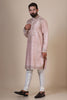 Indulge in elegance with our Pink Kurta, crafted from fine Raw-Silk fabric. Tonal floral embroidery adorns the neck, shoulders, arms, and sides for a captivating look.