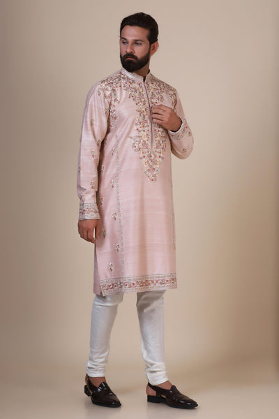 Indulge in elegance with our Pink Kurta, crafted from fine Raw-Silk fabric. Tonal floral embroidery adorns the neck, shoulders, arms, and sides for a captivating look.