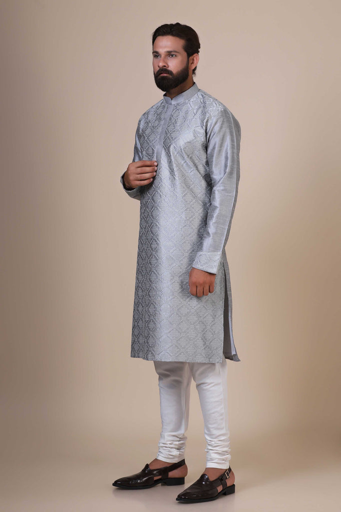 Indulge in comfort and style with our Grey kurta pajama, crafted from blended cotton and silk fabric. Delicate geometric embroidery adorns the front, adding a touch of sophistication.