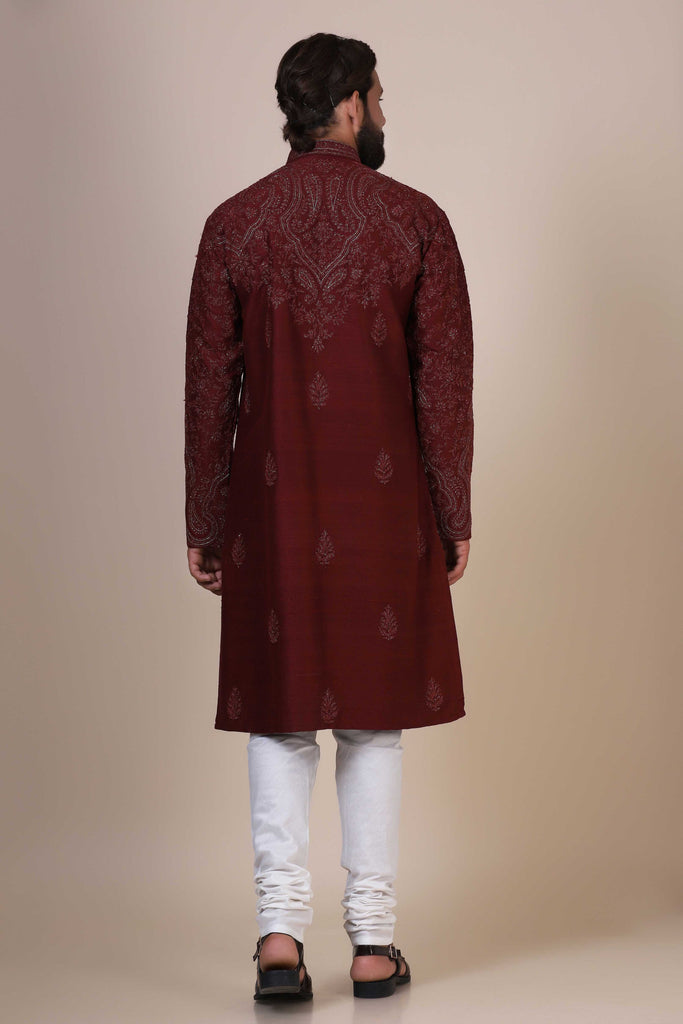 Elegance meets tradition in this maroon Kurta adorned with heavy silver embroidery, featuring subtle paisley motifs at the front and border.