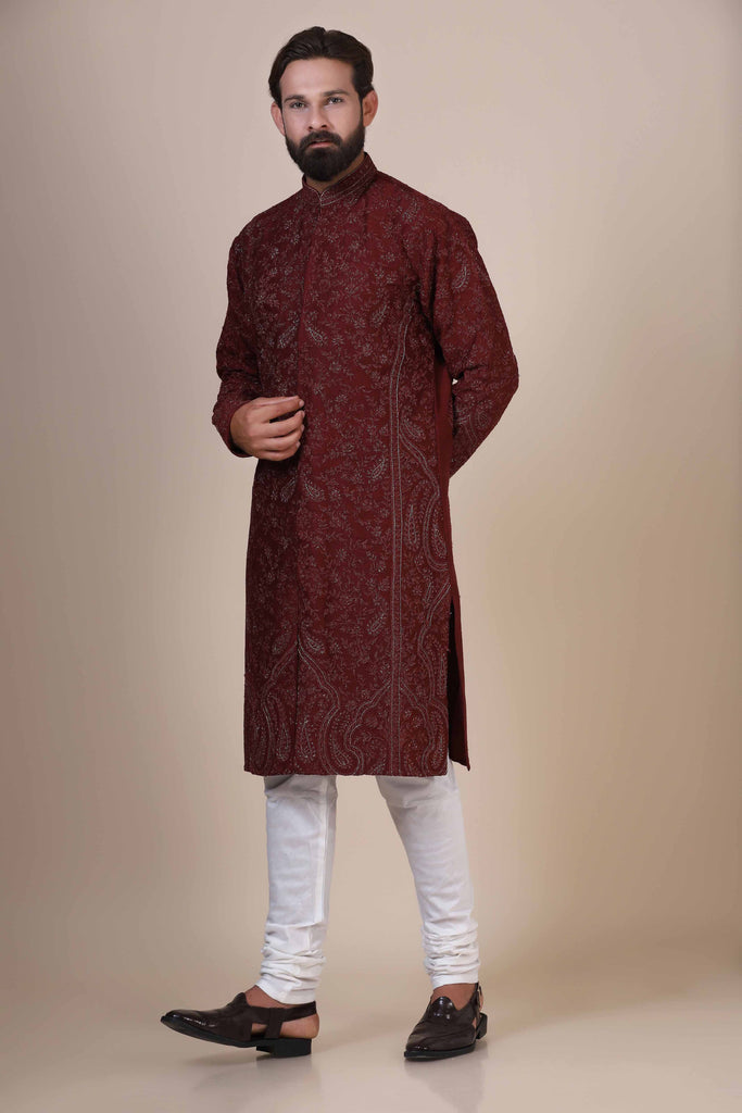 Elegance meets tradition in this maroon Kurta adorned with heavy silver embroidery, featuring subtle paisley motifs at the front and border.