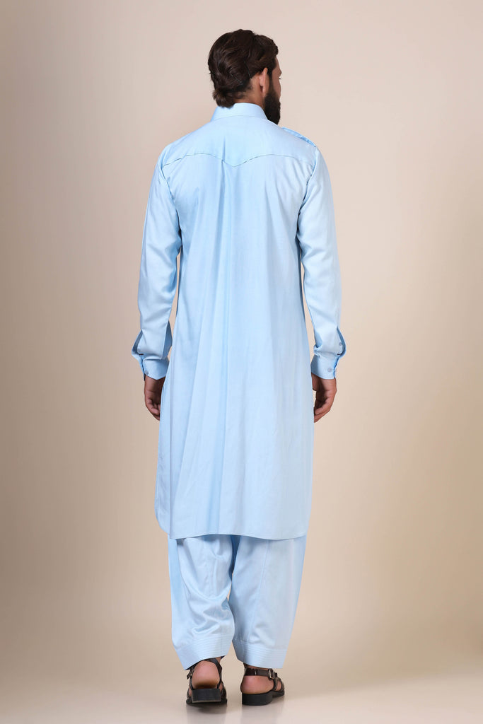 Elevate your style with this Light Blue pathani suit, tailored from flowing modal fabric. Featuring traditional collared neck, double chest patch pockets, and shoulder flaps for a timeless look.