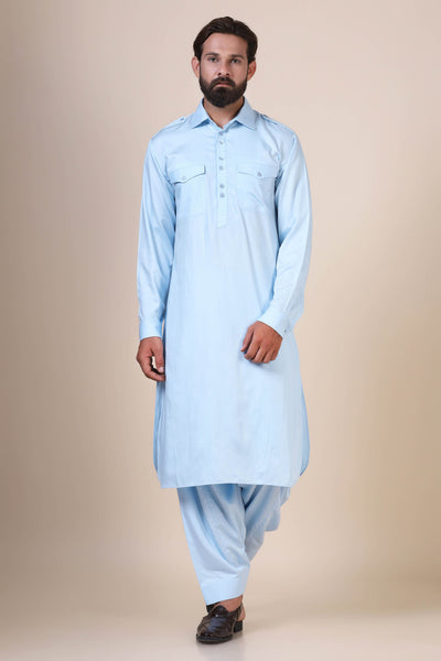 Elevate your style with this Light Blue pathani suit, tailored from flowing modal fabric. Featuring traditional collared neck, double chest patch pockets, and shoulder flaps for a timeless look.