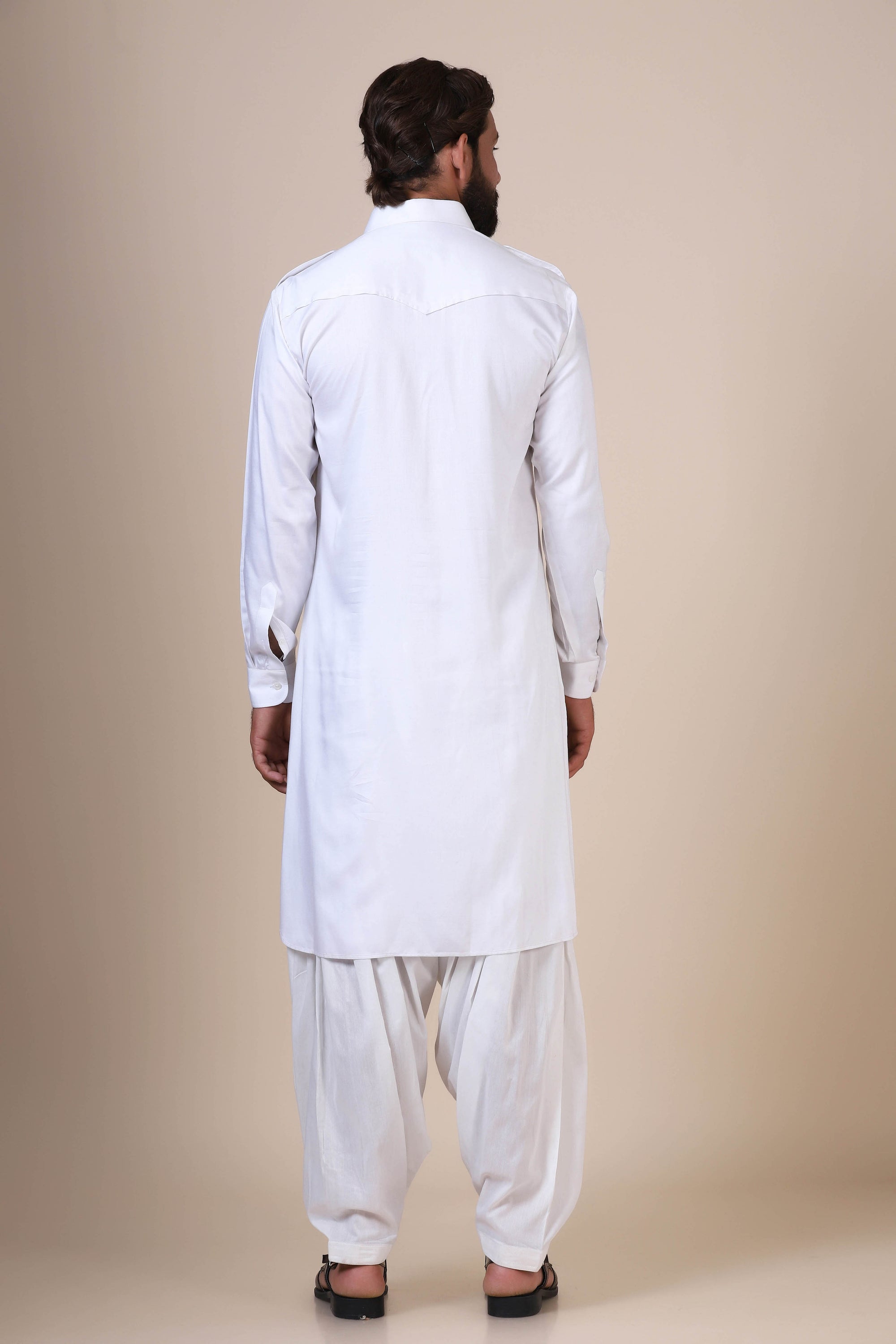 Crafted in flowing modal fabric, this White pathani suit exudes traditional charm. Shop Now!