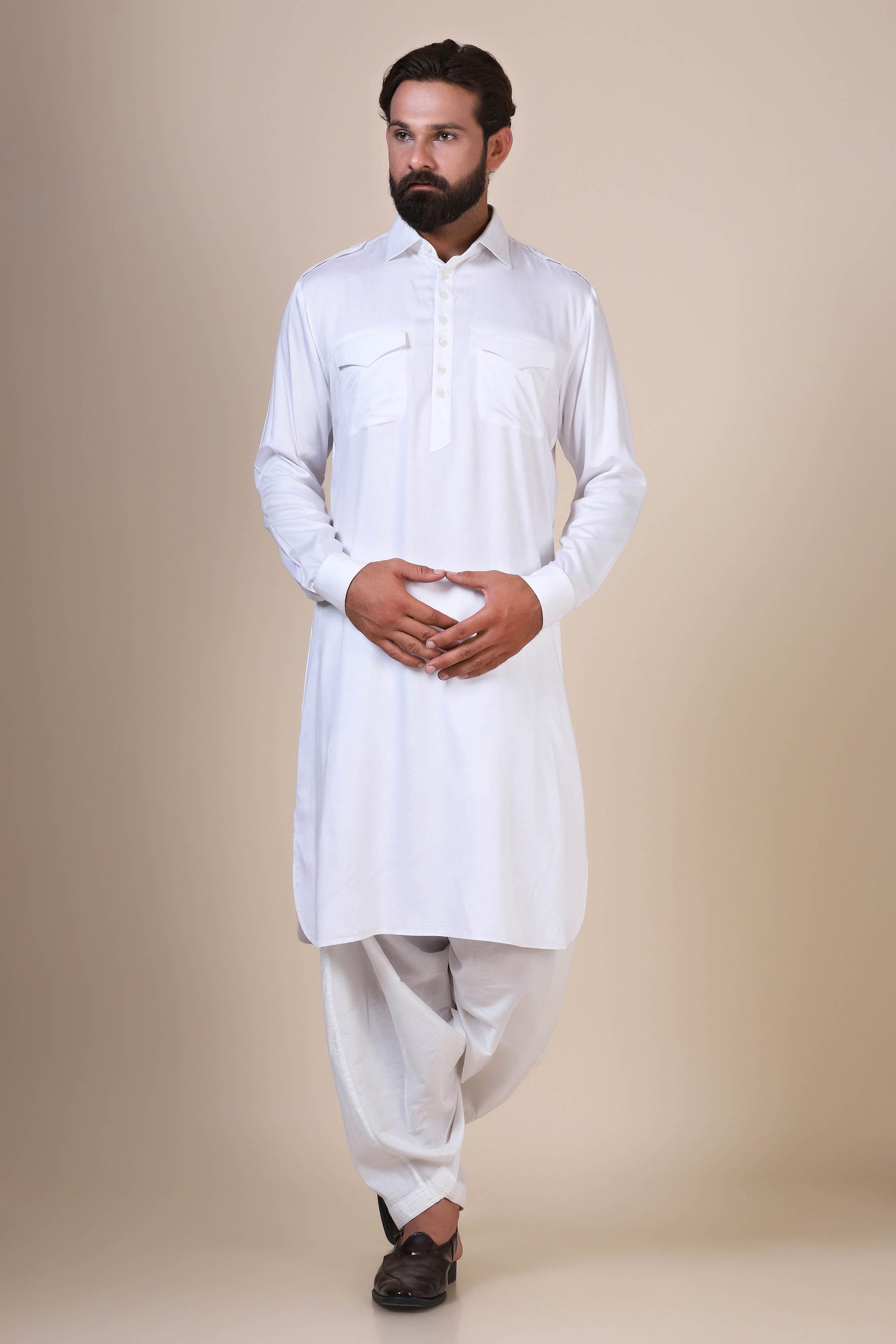 Crafted in flowing modal fabric, this White pathani suit exudes traditional charm. Shop Now!