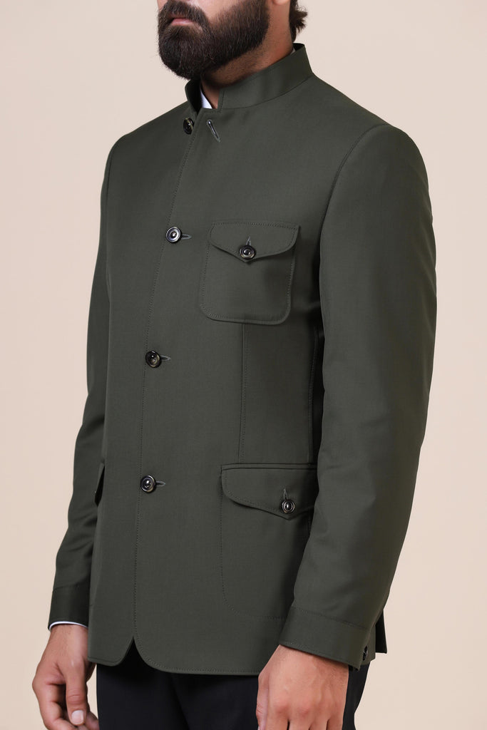 Dress with elegance in our Olive Bandhgala suit, crafted from all-wool fabric. Inspired by the safari jacket, featuring patch pockets with operational flaps for a timeless look.