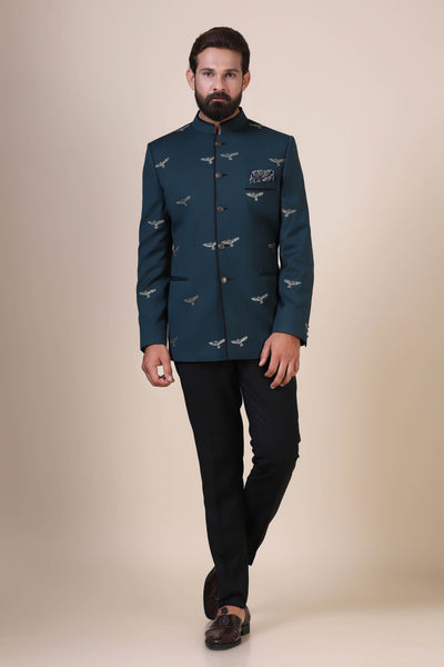 Elevate your style with our Teal Bandhgala suit, tailored from pure wool fabric. Adorned with eagle motif embroidery, paired with jet black trousers for a refined ensemble.