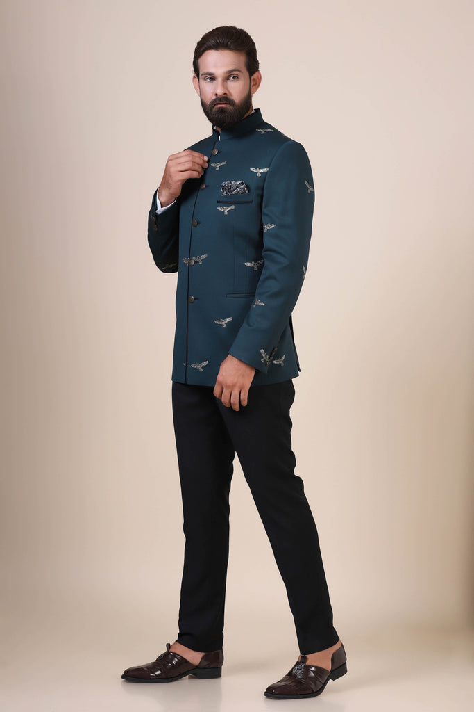 Elevate your style with our Teal Bandhgala suit, tailored from pure wool fabric. Adorned with eagle motif embroidery, paired with jet black trousers for a refined ensemble.