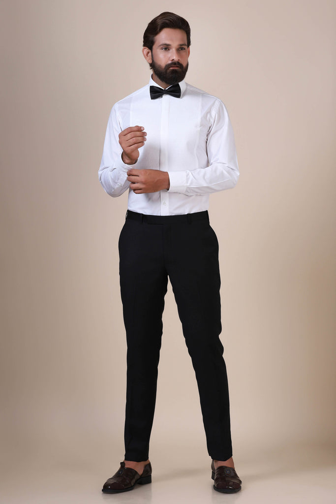 Crafted from premium cotton, this white tuxedo shirt showcases geometric pintucks on the front, a concealed button placket, and a classic collar.