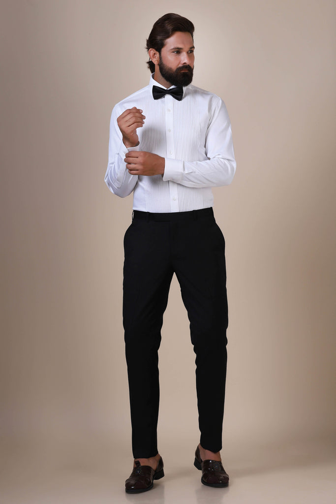 Crafted from fine quality cotton, our white classic tuxedo shirt showcases vertical pintucks on the front, complemented by white buttons and a regular shirt collar.