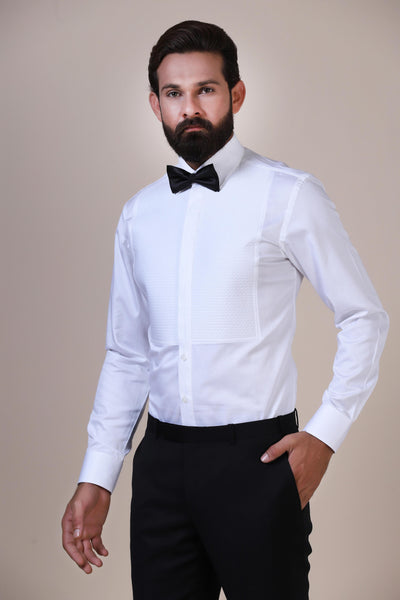 Exuding elegance, our white classic tuxedo shirt boasts fine cotton fabric, a geometric quilted design on the front, white buttons, and a regular shirt collar.