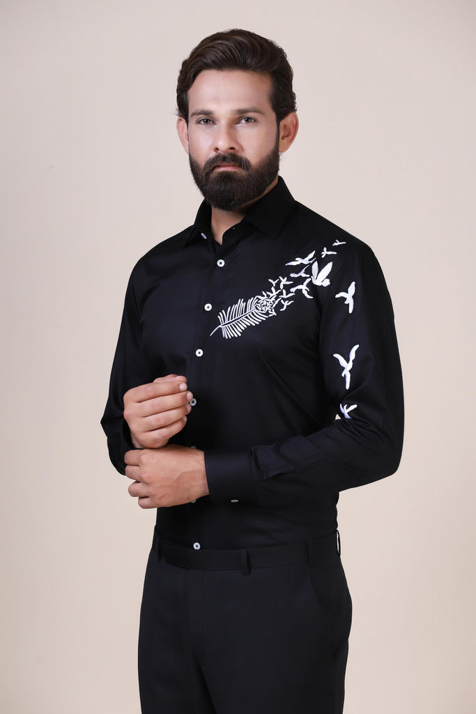 Make a statement in black with our contrast-embroidered shirt. From the sleeve to the chest, it's a modern twist on classic sophistication. Regular collar, white buttons.