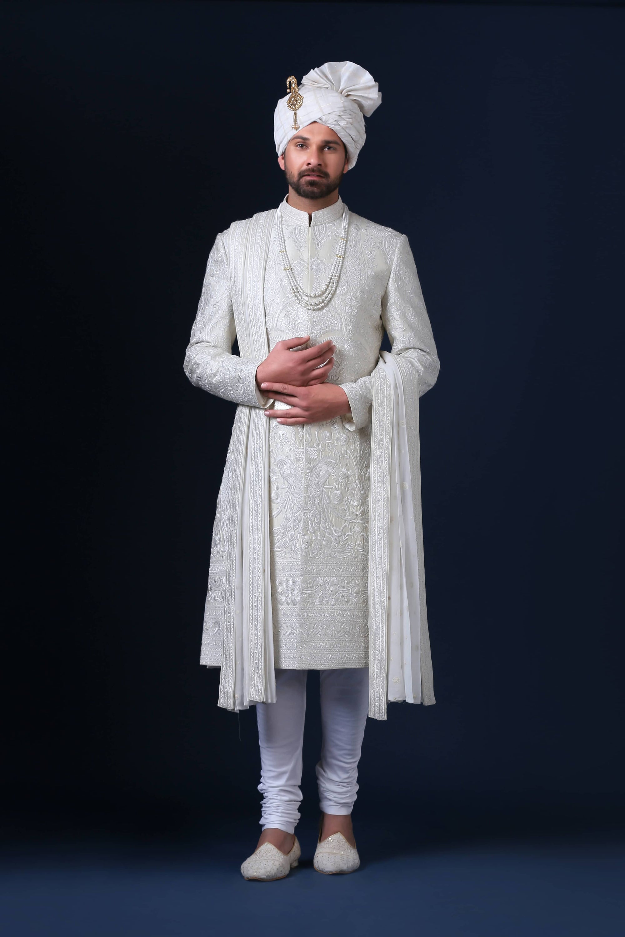 Timeless elegance embodied in this ivory Sherwani, adorned with tonal white embroidery. Shop Now!
