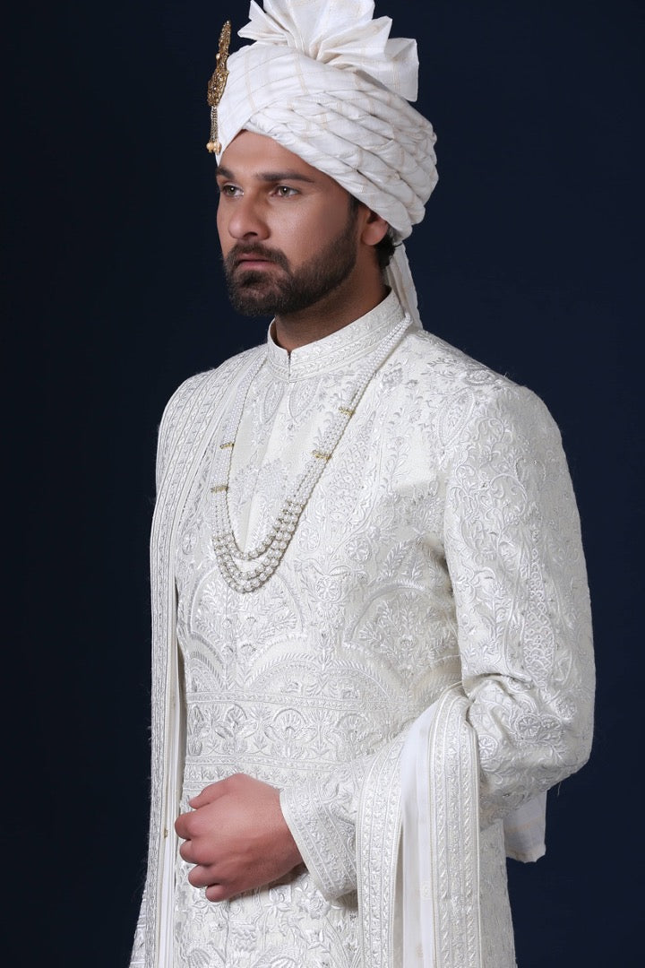 Timeless elegance embodied in this ivory Sherwani, adorned with tonal white embroidery. Shop Now!