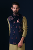 Elevate your style with our Navy Blue velvet Nehru jacket, adorned with contrasting floral embroidery. Paired perfectly with an olive kurta and off-white churidar trousers.
