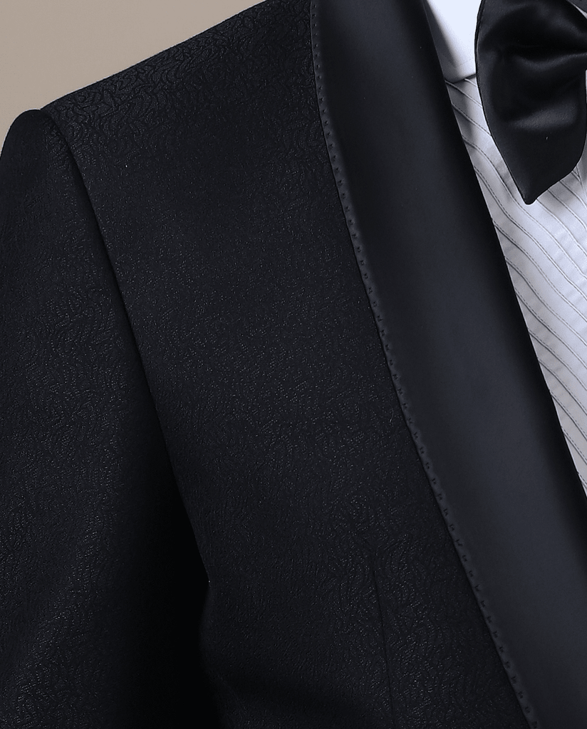 Step into sophistication with our contemporary Tuxedo. Shawl collar, single button closure. Lightweight jacquard coat, tapered trousers in jet-black fabric.